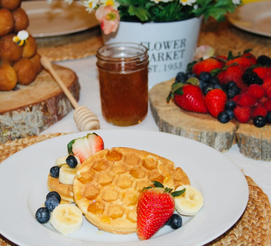 HONEY WAFFLES Serve adorable honey waffles for your next Winnie the Pooh themed brunch. These sweet and fluffy honeycomb shaped waffles are delicious topped with fresh berries and bananas and drizzled with honey.