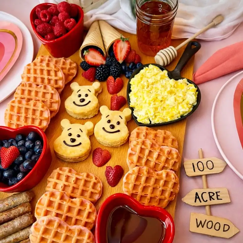 Winnie the Pooh breakfast board with Pooh pancakes, heart waffles, berries, and honey — Winnie the Pooh recipes