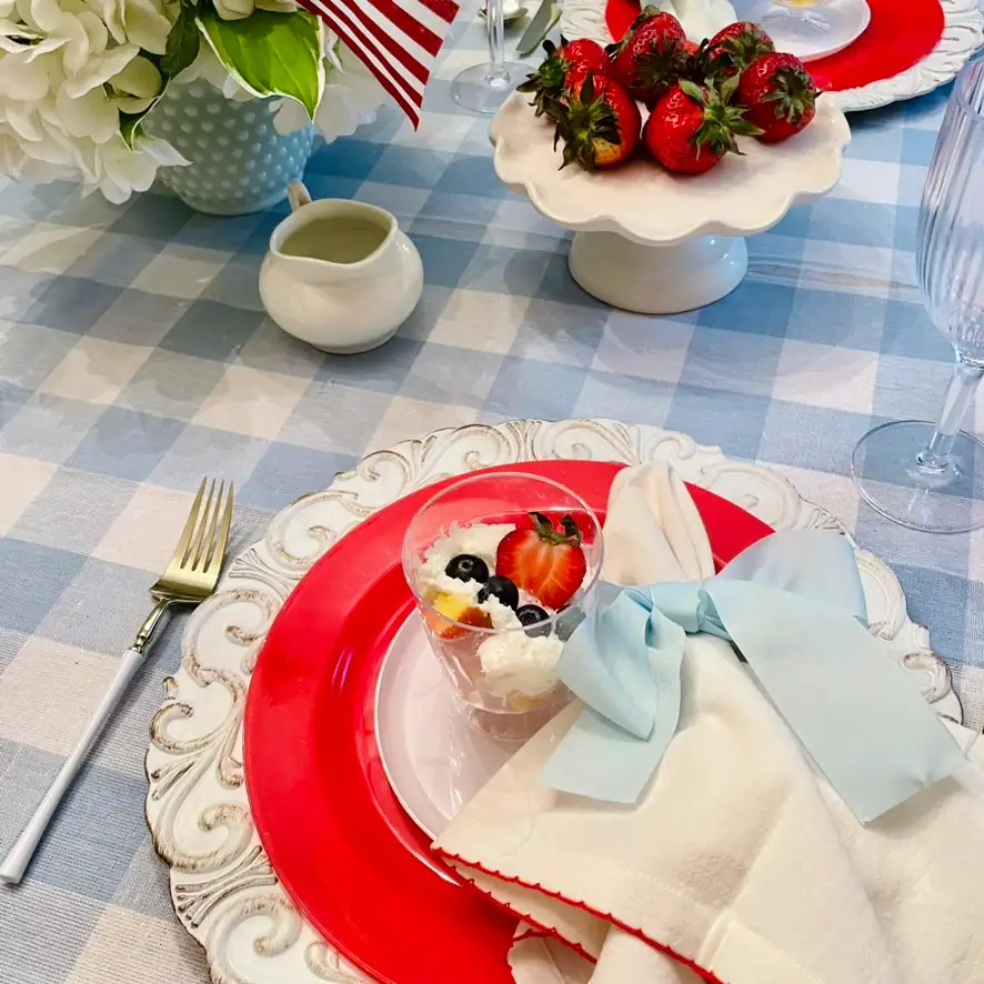 Mini berry trifle cups with whipped cream, strawberries, and blueberries on a red white and blue cottage tablescape — easy 4th of July dessert
