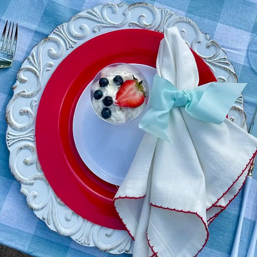 Mini berry trifle cups with whipped cream, strawberries, and blueberries on a red white and blue cottage tablescape — easy 4th of July dessert